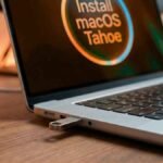 A USB flash drive inserted into a MacBook Pro M5 for a clean macOS installation.