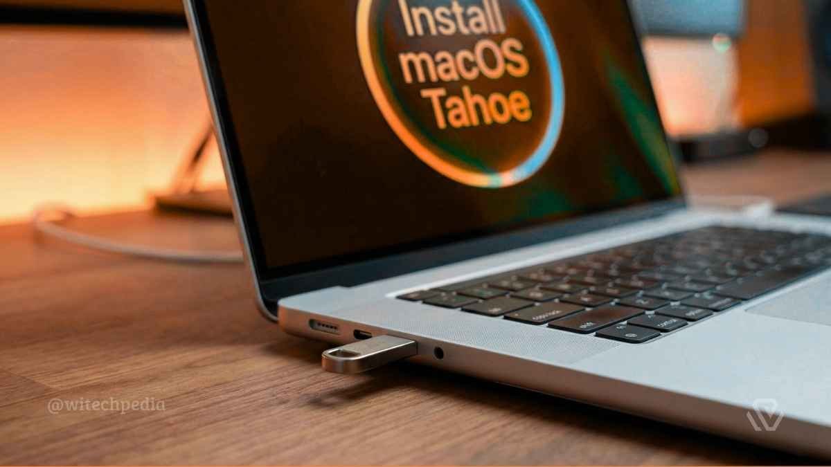 A USB flash drive inserted into a MacBook Pro M5 for a clean macOS installation.